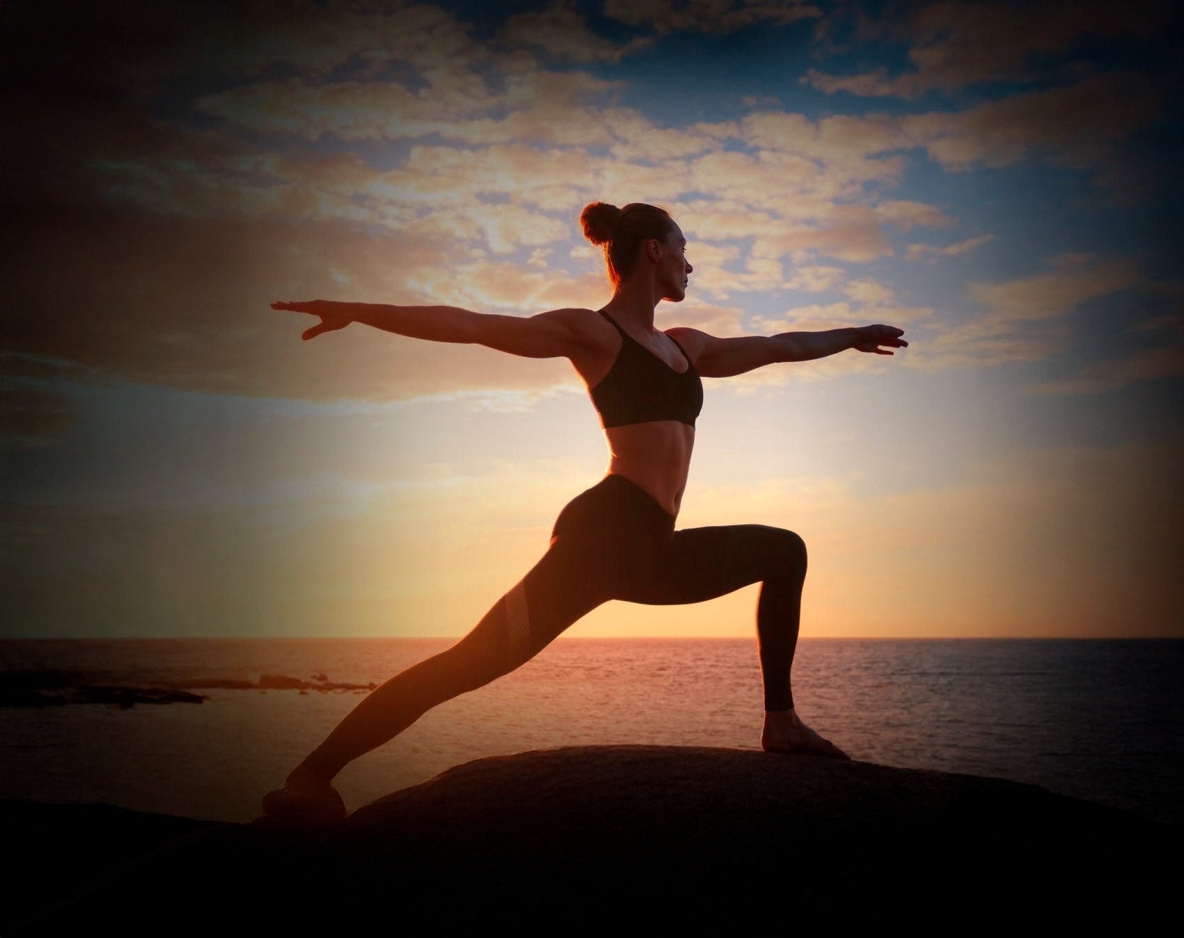 Yoga at sunset over the ocean